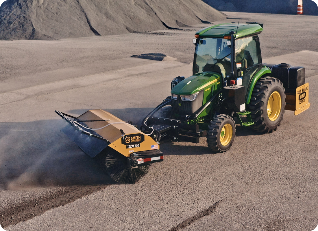 sweeper operating on dusty road